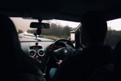 Driver inside a car with hands on the steering wheel